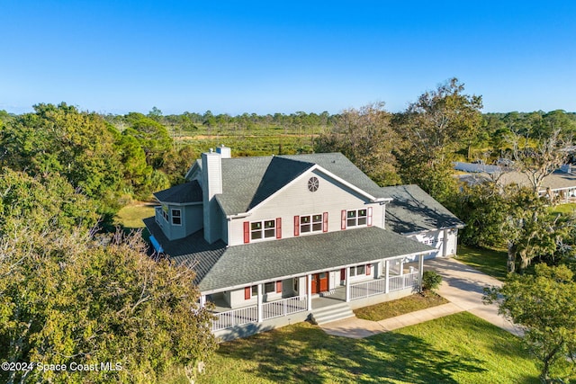 view of front of home with a porch and a front lawn