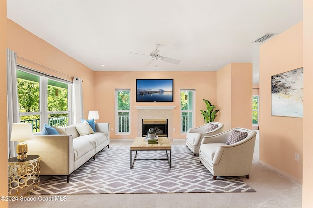 carpeted living room with ceiling fan