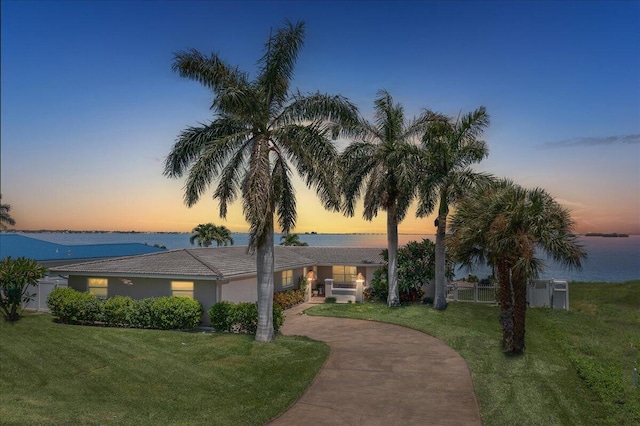 view of front of house featuring a water view and a yard