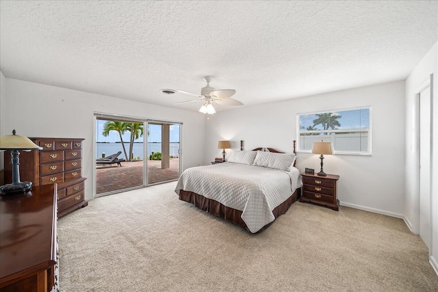 bedroom featuring light carpet, a textured ceiling, access to outside, and ceiling fan