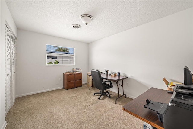 home office with light carpet and a textured ceiling