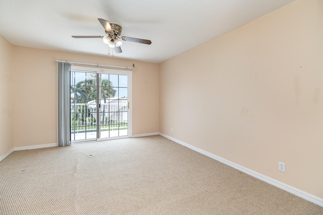 unfurnished room featuring ceiling fan and carpet flooring