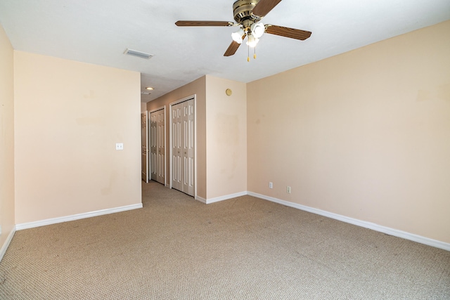 carpeted empty room with ceiling fan