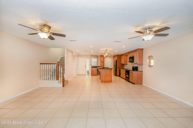 interior space with light tile patterned flooring, ceiling fan, and a textured ceiling