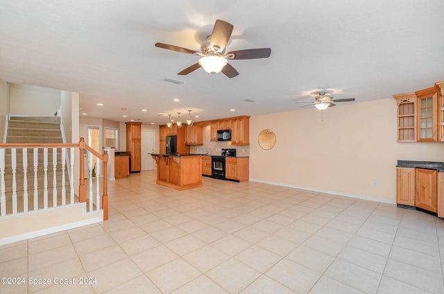 unfurnished living room with ceiling fan and light tile patterned floors