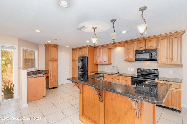 kitchen with a kitchen island, decorative light fixtures, black appliances, and sink