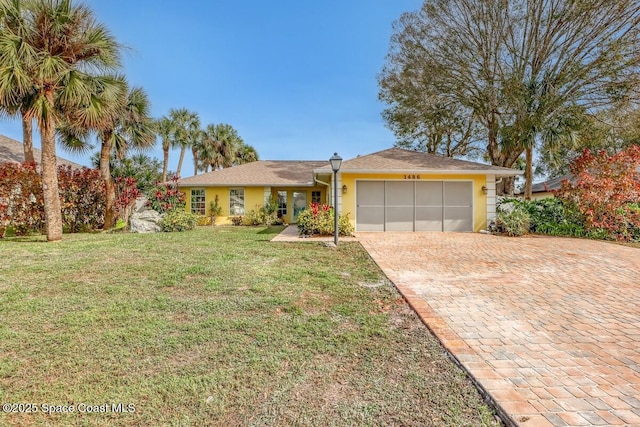 single story home featuring a garage and a front lawn