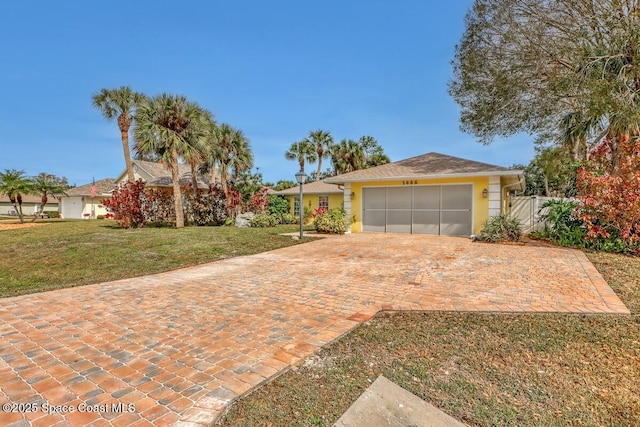 view of front of house featuring a garage and a front lawn