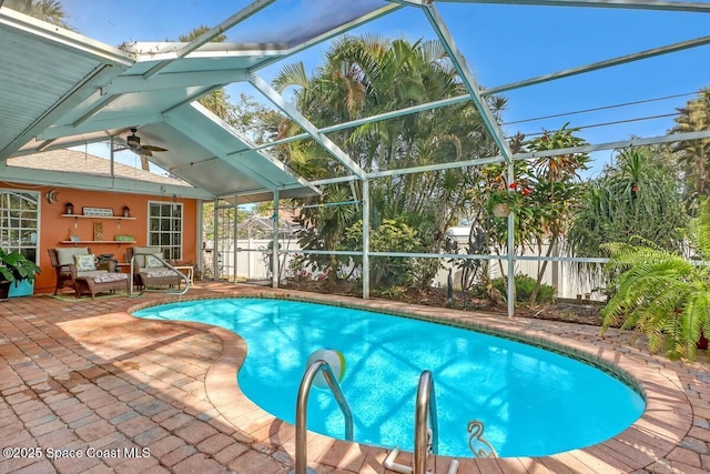 view of swimming pool featuring glass enclosure and a patio area