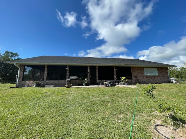 rear view of house with a yard