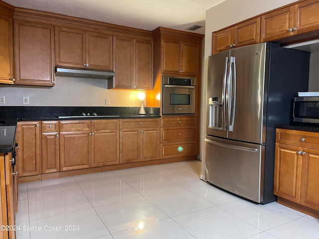 kitchen with light tile patterned flooring and appliances with stainless steel finishes