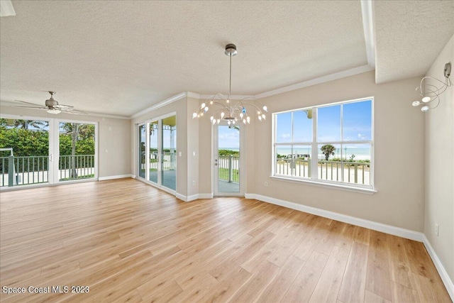 unfurnished dining area with a water view, ceiling fan with notable chandelier, a textured ceiling, and light hardwood / wood-style floors