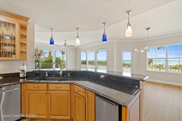 kitchen featuring dishwasher, a textured ceiling, pendant lighting, ceiling fan with notable chandelier, and sink