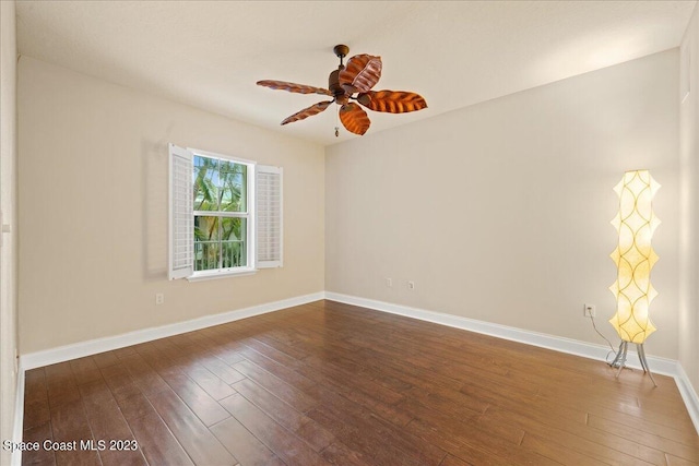 unfurnished room with ceiling fan and dark hardwood / wood-style floors