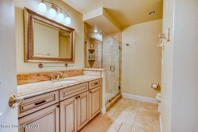 bathroom featuring walk in shower, vanity, tile patterned flooring, toilet, and a textured ceiling