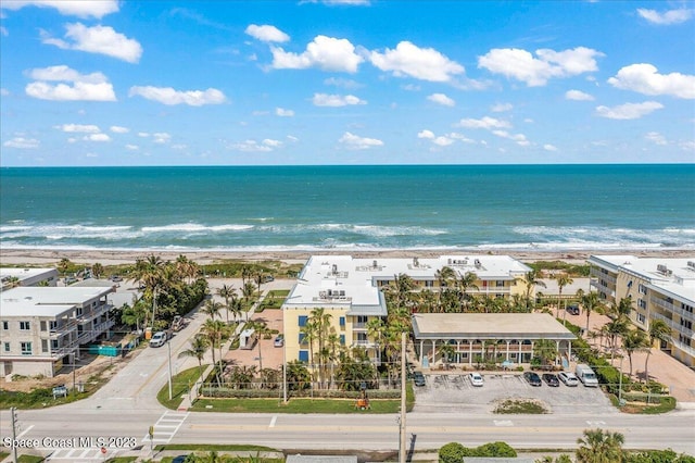 bird's eye view featuring a water view and a beach view