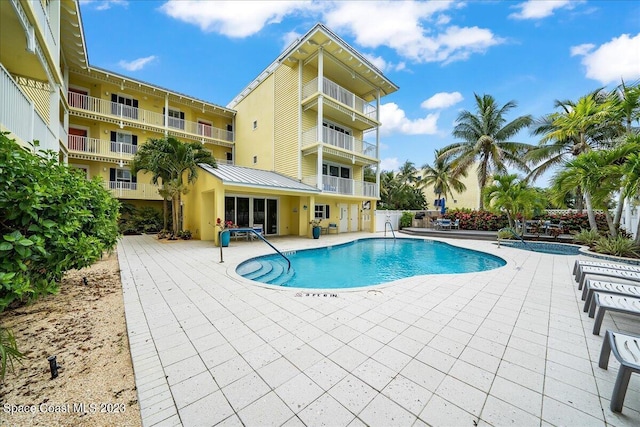 view of swimming pool featuring a patio area