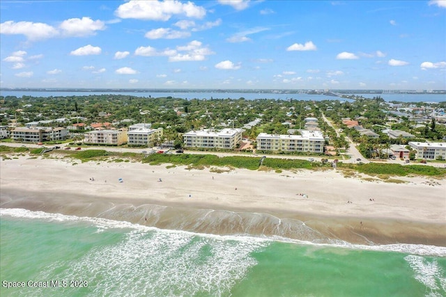 bird's eye view featuring a view of the beach and a water view