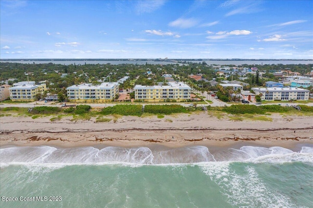 drone / aerial view with a beach view and a water view