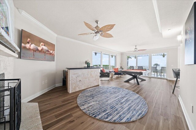 recreation room featuring a textured ceiling, crown molding, pool table, and wood-type flooring