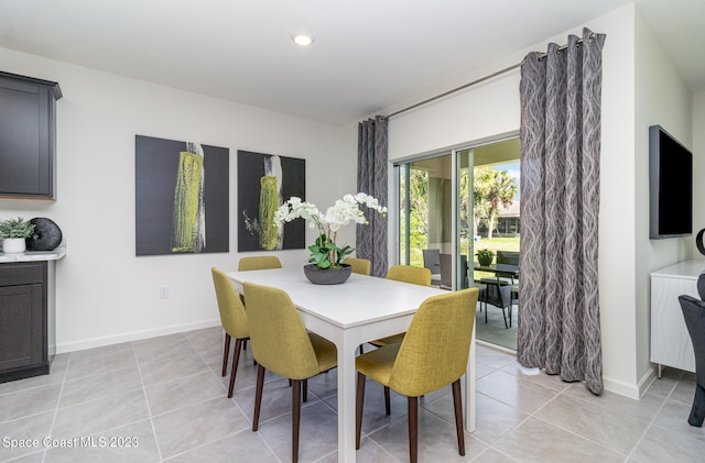 dining space featuring light tile patterned floors