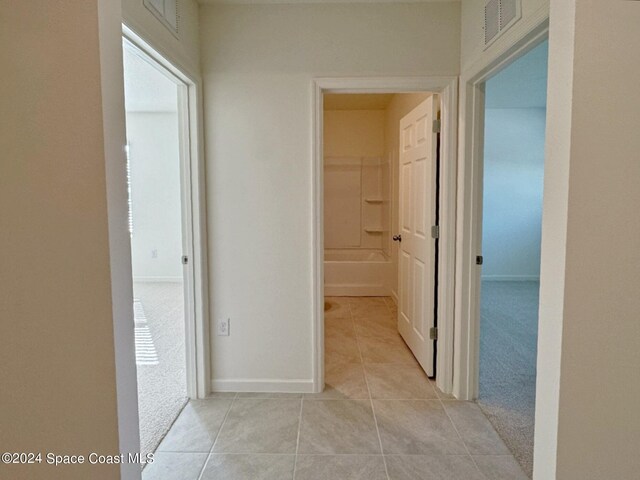 corridor featuring light tile patterned flooring