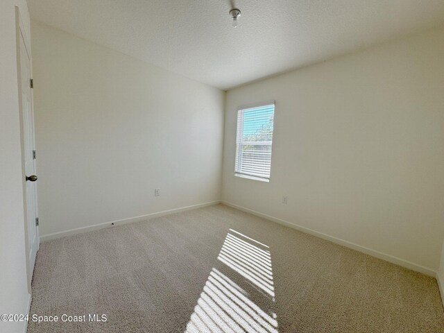 unfurnished room with light colored carpet