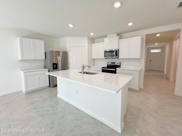 kitchen featuring white cabinetry, appliances with stainless steel finishes, sink, and a center island with sink