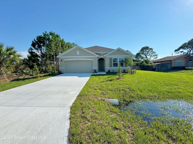 ranch-style home with a garage and a front yard