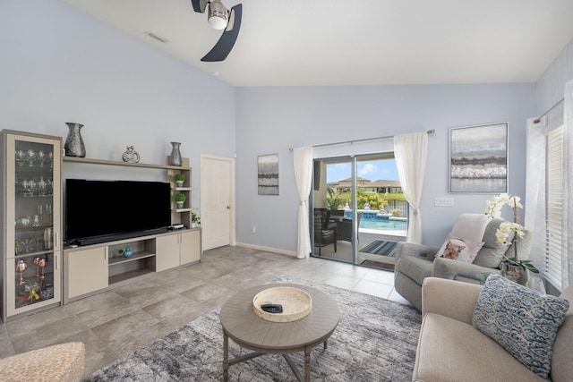 tiled living room with lofted ceiling and ceiling fan