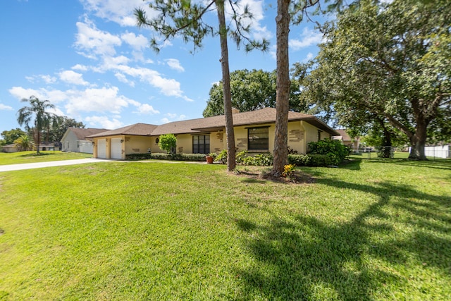 ranch-style home with a garage and a front lawn