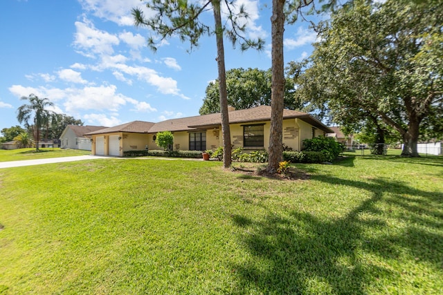 ranch-style house featuring a garage and a front lawn