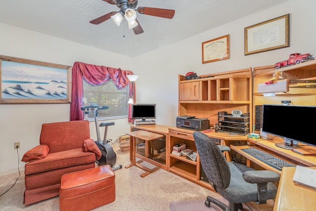 carpeted office with ceiling fan and a textured ceiling