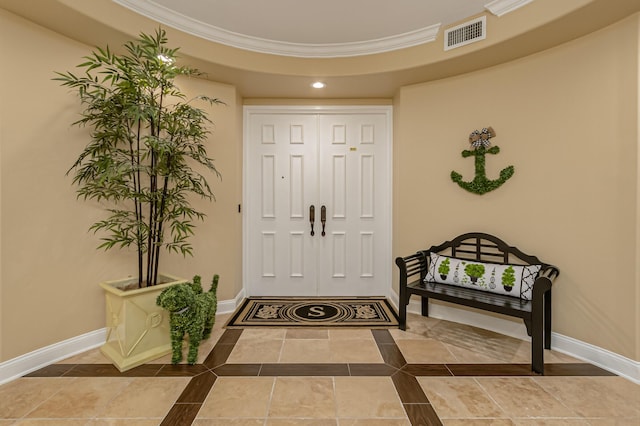 entryway with crown molding and tile patterned flooring