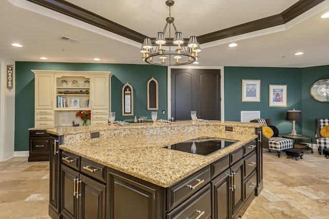 kitchen with crown molding, black electric cooktop, dark brown cabinetry, and a tray ceiling