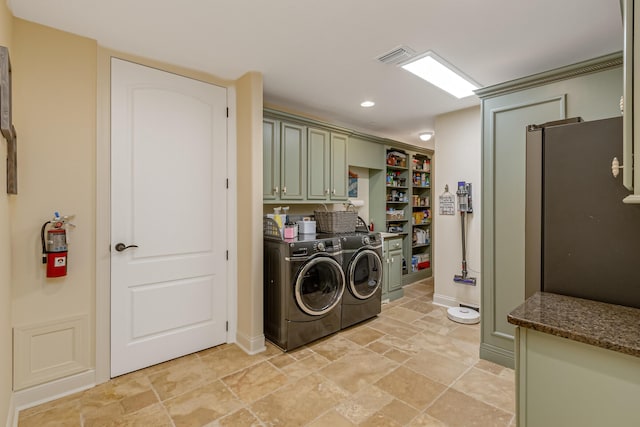 washroom featuring cabinets and separate washer and dryer