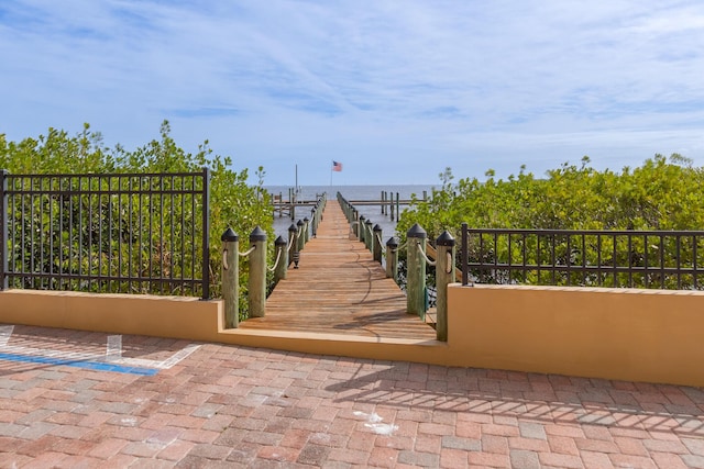 exterior space with a water view and a dock