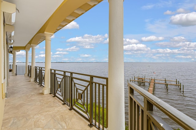 dock area featuring a balcony and a water view