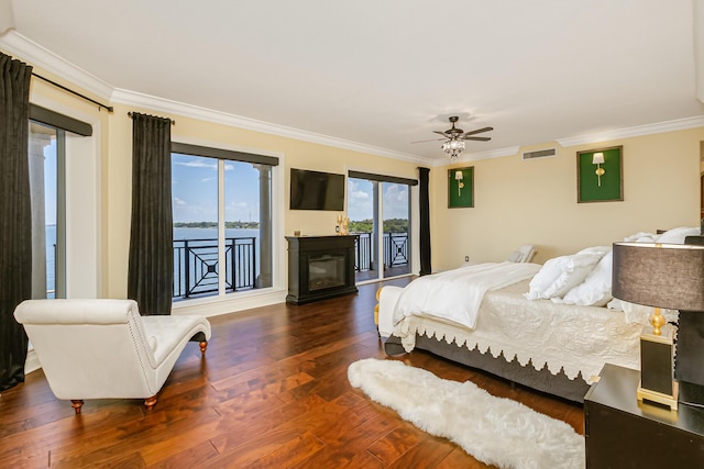 bedroom with ornamental molding, dark hardwood / wood-style floors, access to exterior, and ceiling fan