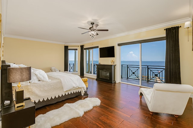 bedroom with ornamental molding, dark wood-type flooring, access to exterior, and ceiling fan