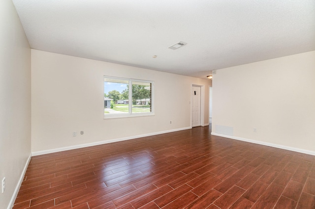 spare room with wood-type flooring