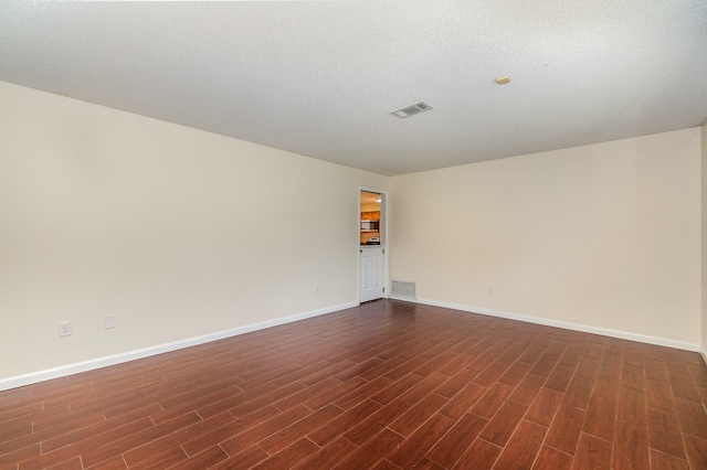 unfurnished room featuring hardwood / wood-style floors and a textured ceiling