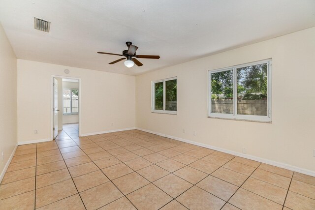 unfurnished room featuring light tile patterned floors and ceiling fan