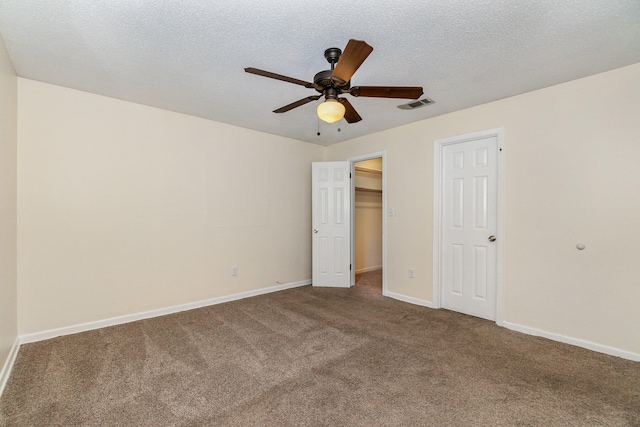 unfurnished bedroom with carpet floors, a textured ceiling, and ceiling fan