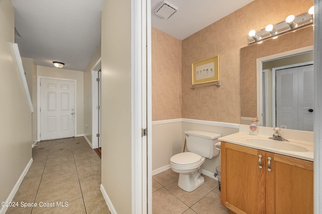 bathroom with vanity, toilet, and tile patterned floors