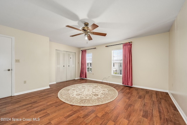 empty room with wood-type flooring and ceiling fan