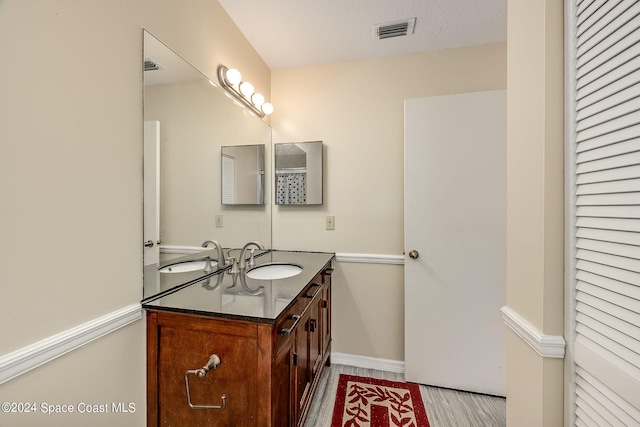 bathroom with vanity and hardwood / wood-style floors