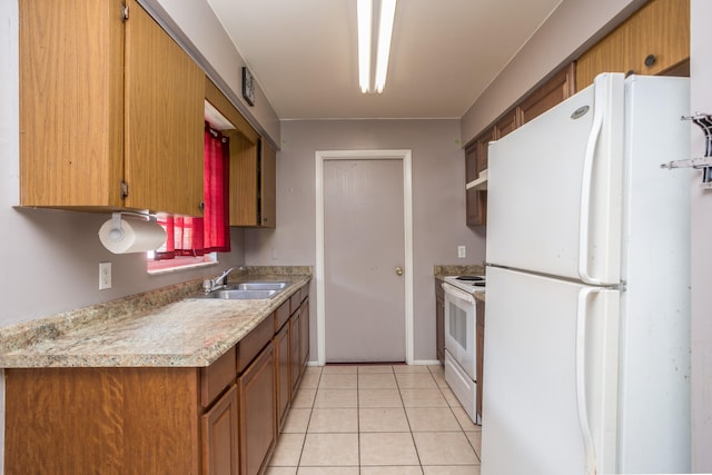 kitchen with sink, white appliances, and light tile patterned floors