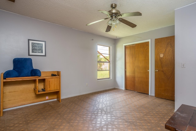 tiled bedroom featuring a textured ceiling and ceiling fan