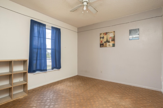 spare room with a textured ceiling and ceiling fan